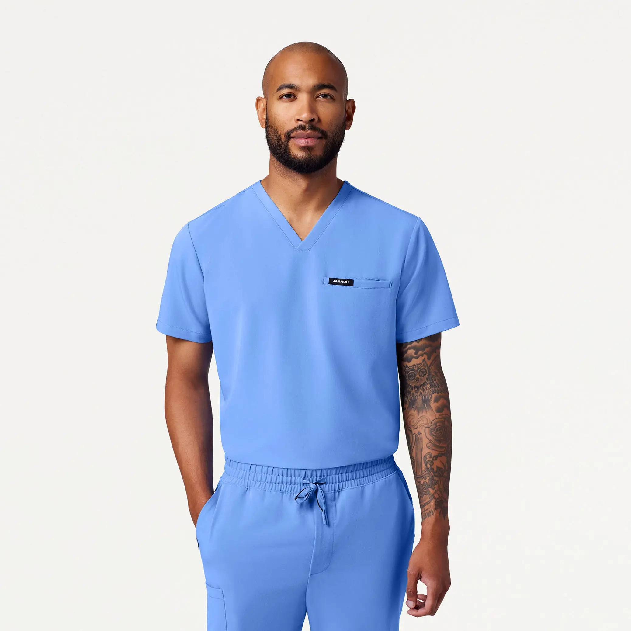 Reduced Price Jaanuu Men's Romin 1-Pocket Scrub Top - Ceil Blue